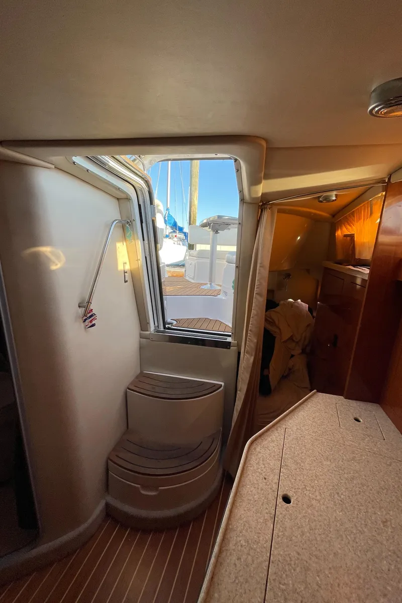 Slide: The Image of Interior of 2006 Regal 3060 Window Express yacht, featuring cabin and window view. - 13