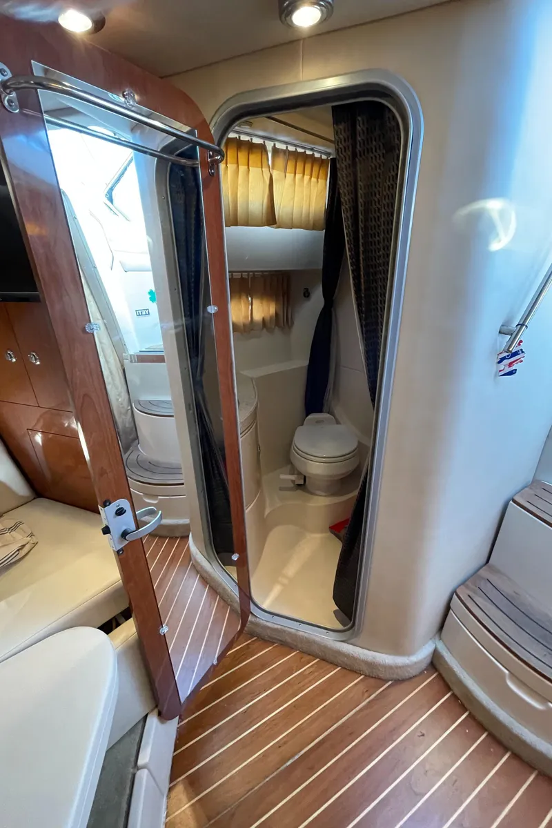 Slide: The Image of 2006 Regal 3060 Window Express yacht interior with bathroom, wooden flooring, and modern design. - 14
