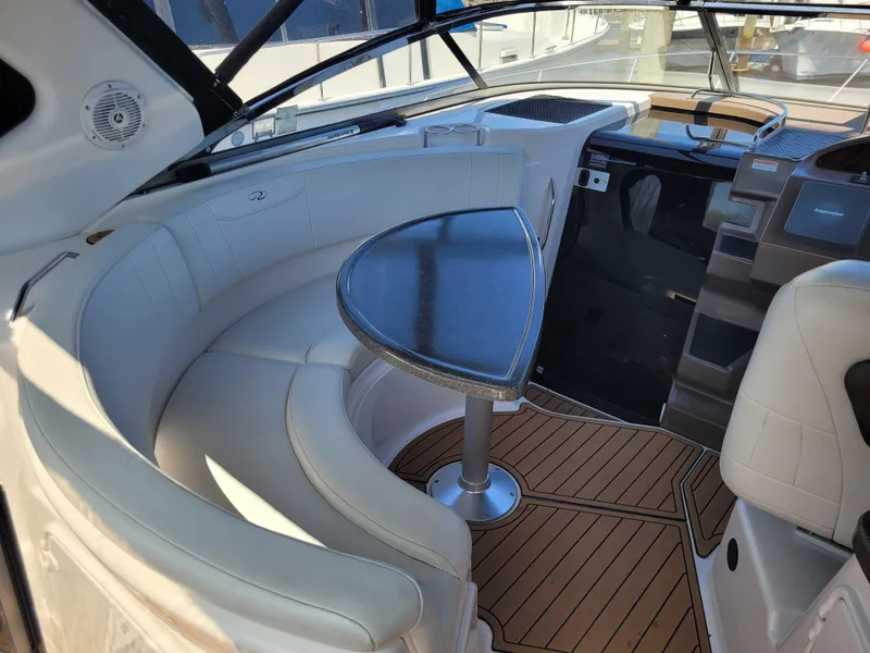 Slide: The Image of 2006 Regal 3060 Window Express boat interior with curved seating and wooden flooring. - 17