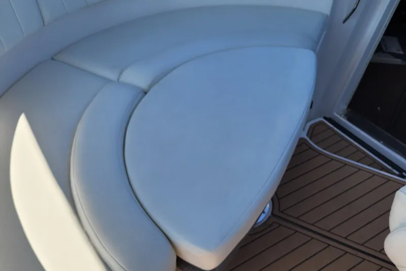 Slide: The Image of 2006 Regal 3060 Window Express boat interior with white cushioned seating and wooden flooring. - 20