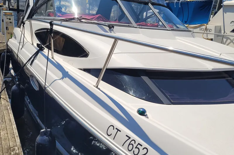 Slide: The Image of 2006 Regal 3060 Window Express boat docked, showcasing sleek design and modern features. - 28