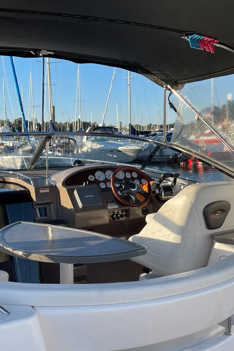 Slide: The Image of 2006 Regal 3060 Window Express boat interior with steering wheel and dashboard. - 6