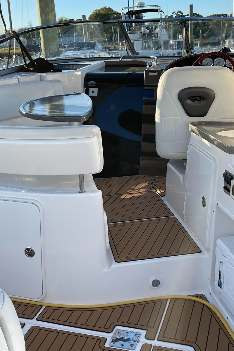 Slide: The Image of 2006 Regal 3060 Window Express boat interior with wood flooring and white seating. - 7