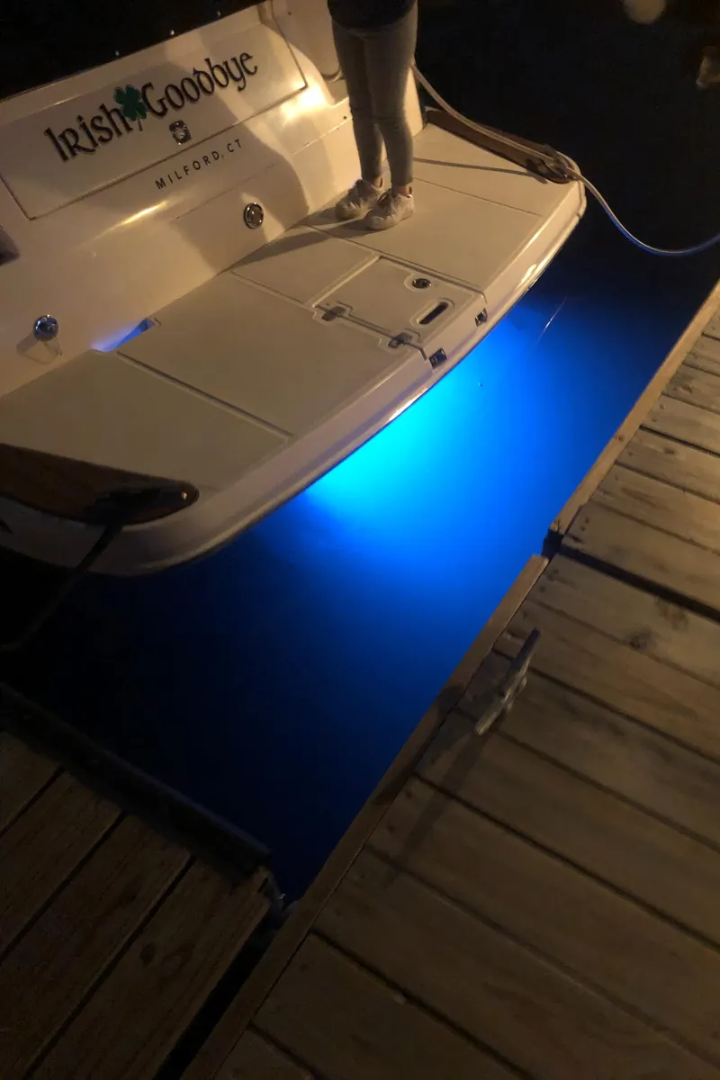 Slide: The Image of 2006 Regal 3060 Window Express boat with blue underwater lights at night. - 9