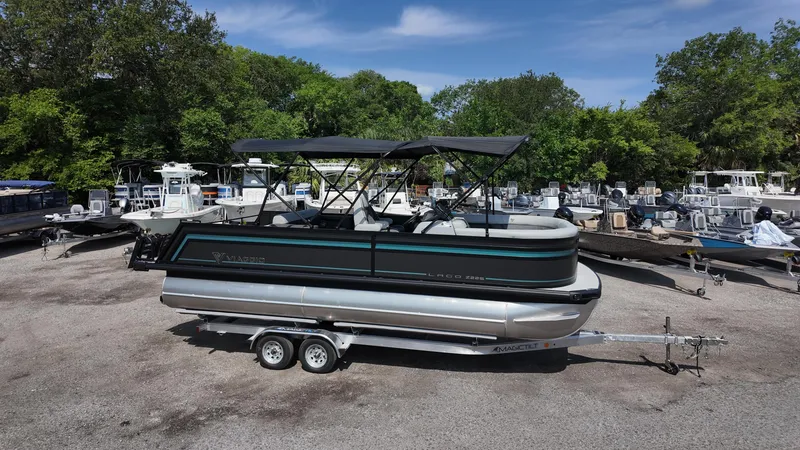 Slide: The Image of 2025 Viaggio Z22S pontoon boat on trailer, parked in marina lot. - 14