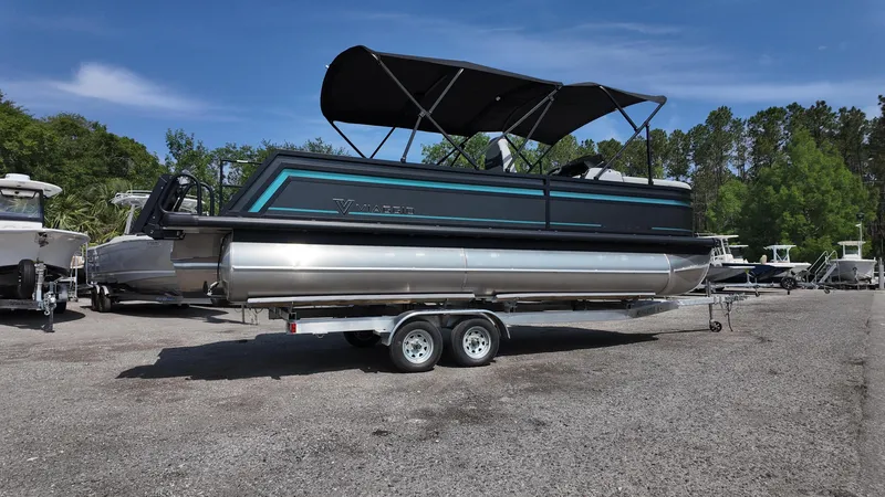 Slide: The Image of 2025 Viaggio Z22S pontoon boat on trailer, parked outdoors under clear sky. - 20