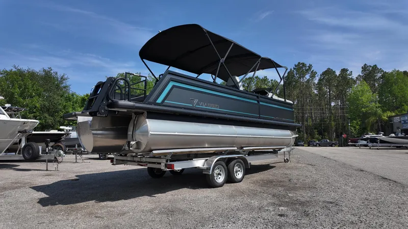Slide: The Image of 2025 Viaggio Z22S pontoon boat on trailer, parked outdoors under clear sky. - 22