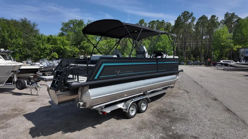 Slide: The Image of 2025 Viaggio Z22S pontoon boat on trailer, parked outdoors. - 23