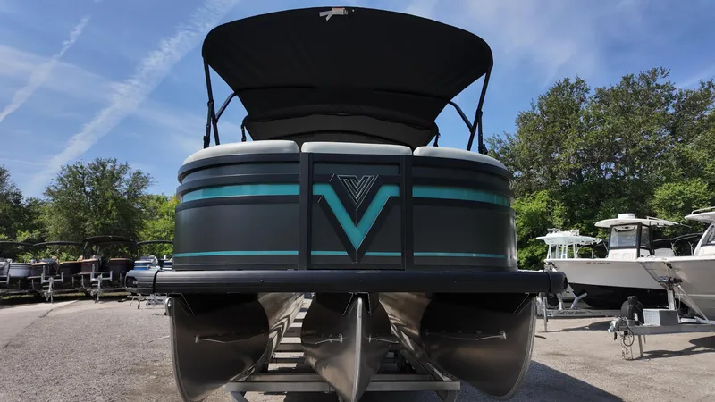 Slide: The Image of 2025 Viaggio Z22S pontoon boat with canopy, parked outdoors under a clear sky. - 26