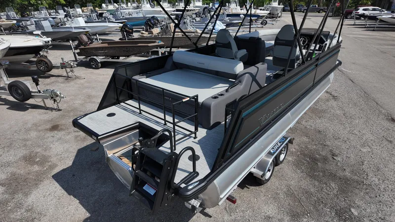 Slide: The Image of 2025 Viaggio Z22S pontoon boat with spacious deck and seating, parked on a trailer. - 27