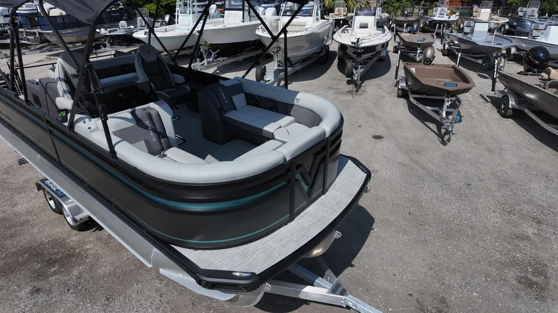 Slide: The Image of 2025 Viaggio Z22S pontoon boat on trailer, surrounded by various boats. - 35