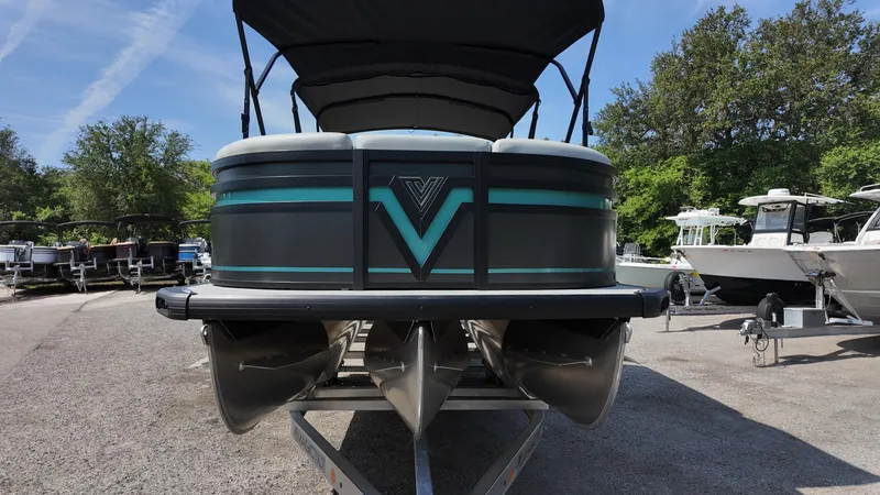 Slide: The Image of 2025 Viaggio Z22S pontoon boat with sleek design and vibrant accents, parked outdoors. - 36