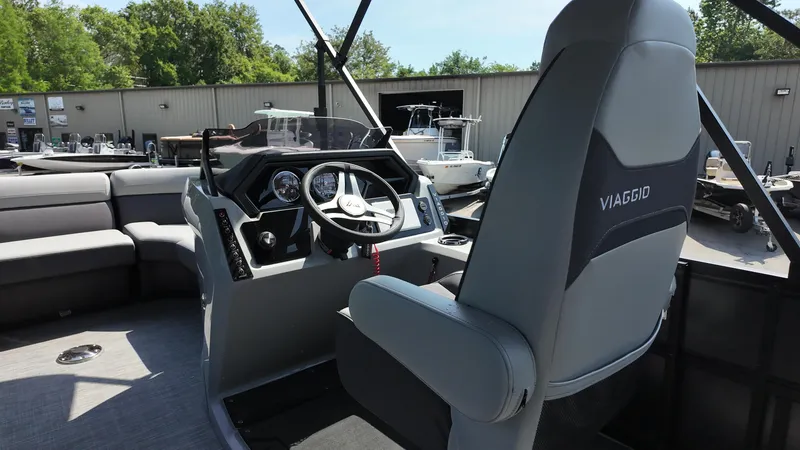 Slide: The Image of 2025 Viaggio Z22S boat interior with steering wheel and seating area. - 39