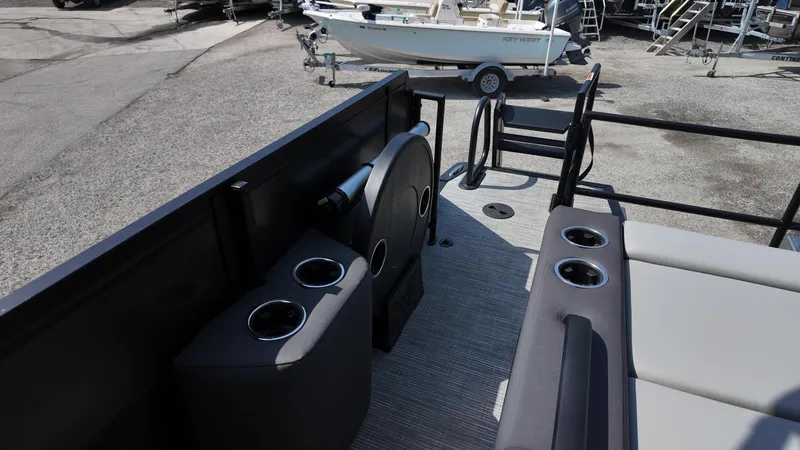 Slide: The Image of 2025 Viaggio Z22S boat interior with cup holders and seating, docked near other boats. - 45