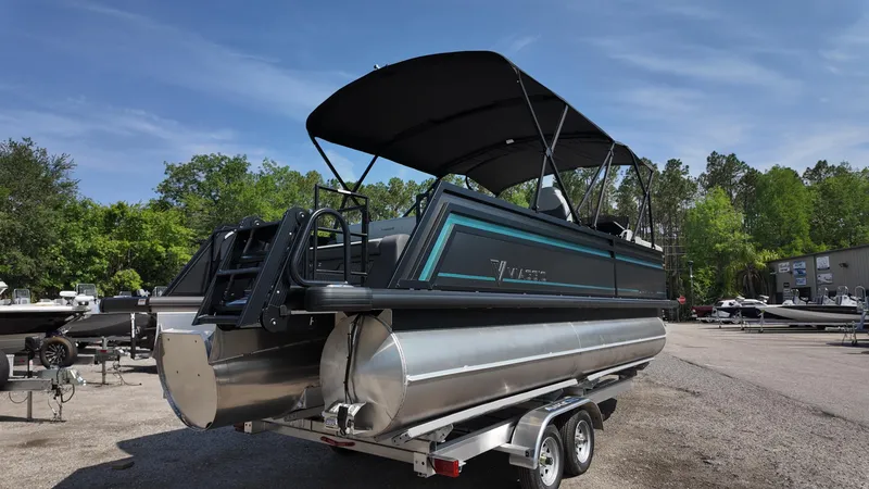 Slide: The Image of 2025 Viaggio Z22S pontoon boat on trailer, parked outdoors under clear sky. - 8