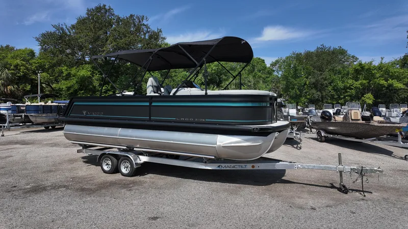 Slide: The Image of 2025 Viaggio Z22S pontoon boat on trailer, parked outdoors under clear sky. - 9
