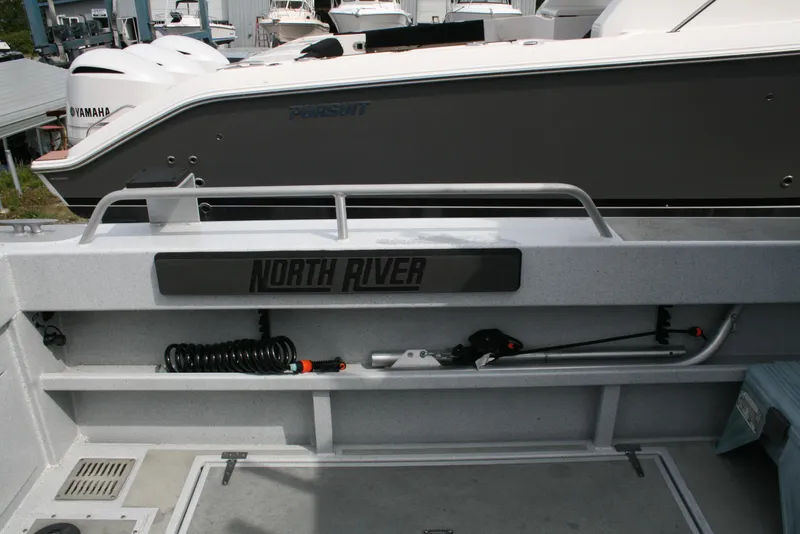 Slide: The Image of 2017 North River 2500 S Sew Hawk OS boat interior with storage and equipment. - 13