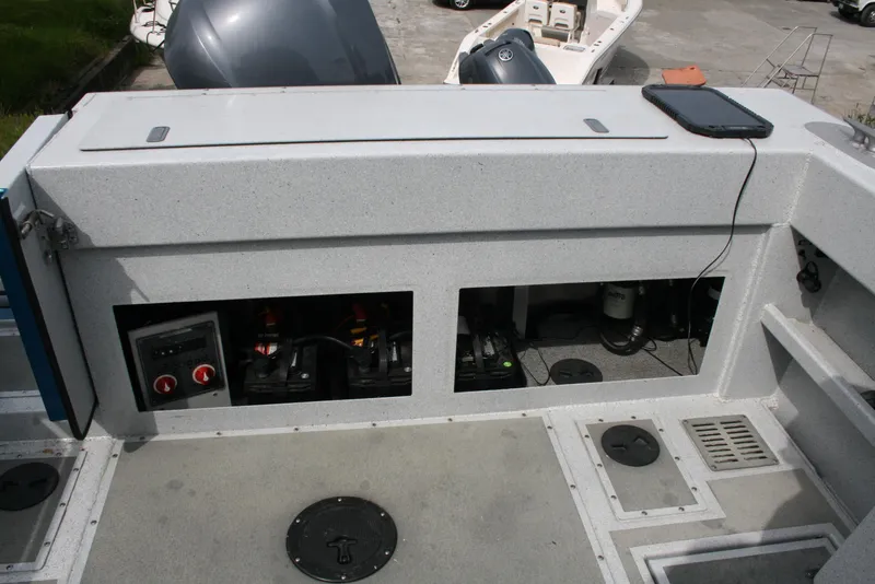 Slide: The Image of 2017 North River 2500 S Sew Hawk OS boat interior with open compartments and equipment. - 15