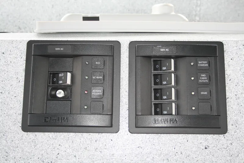 Slide: The Image of Electrical panel of 2017 North River 2500 S Sew Hawk OS boat, featuring switches and circuit breakers. - 28