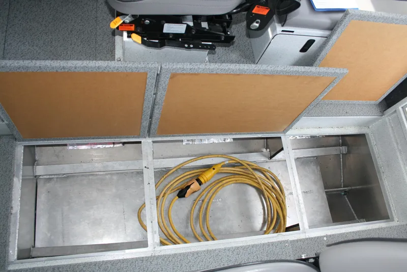 Slide: The Image of 2017 North River 2500 S Sew Hawk OS interior storage with coiled yellow cable. - 29