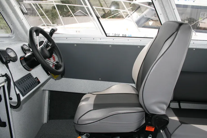 Slide: The Image of Interior of 2017 North River 2500 S Sew Hawk OS boat, featuring steering wheel and captain's seat. - 3