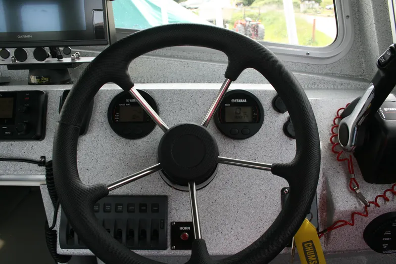 Slide: The Image of Steering wheel and dashboard of 2017 North River 2500 S Sew Hawk OS boat. - 4