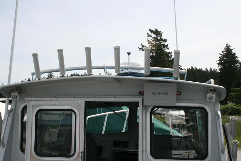 Slide: The Image of 2017 North River 2500 S Sew Hawk OS boat with Garmin equipment, docked near trees. - 41