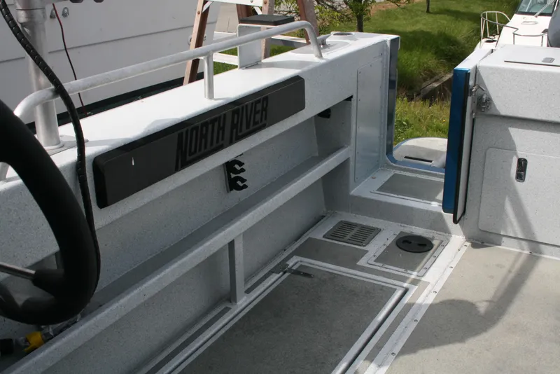 Slide: The Image of 2017 North River 2500 S Sew Hawk OS boat interior with storage compartments. - 42