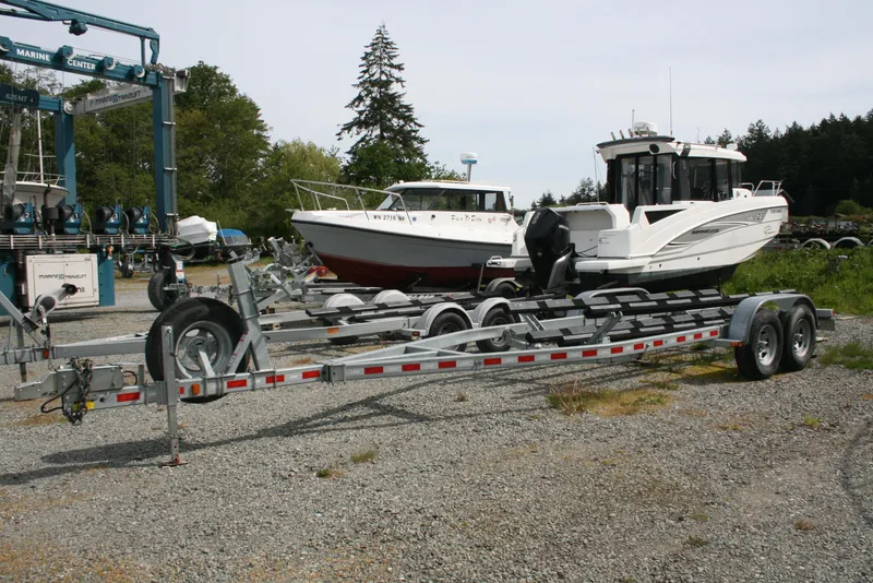 Slide: The Image of 2017 North River 2500 S Sew Hawk OS boat on trailer in a marina setting. - 45