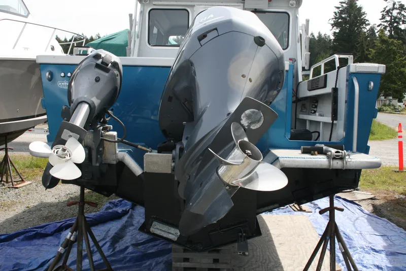 Slide: The Image of 2017 North River 2500 S Sew Hawk OS boat with dual outboard motors on stands. - 47