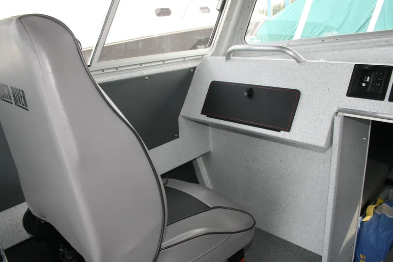 Slide: The Image of Interior of 2017 North River 2500 S Sew Hawk OS boat, featuring a gray seat and dashboard. - 5