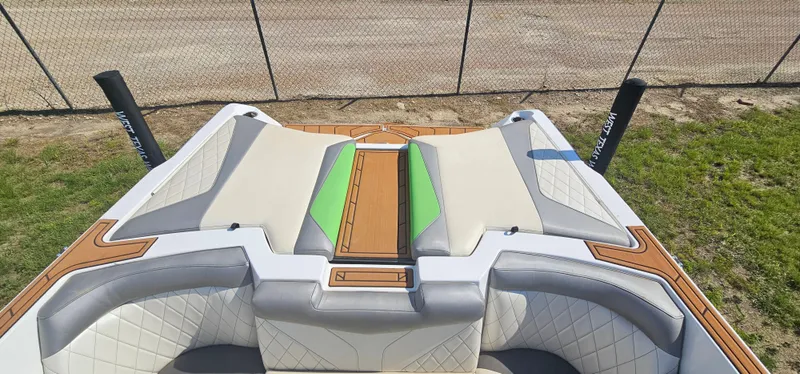 Slide: The Image of 2017 Tigé Z3 boat interior with beige and green seating, wooden accents. - 10