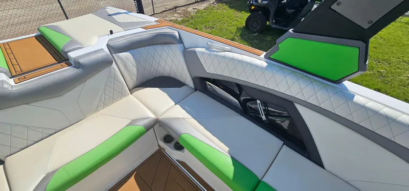 Slide: The Image of 2017 Tigé Z3 boat interior with white and green seating, diamond stitching, and modern design. - 12
