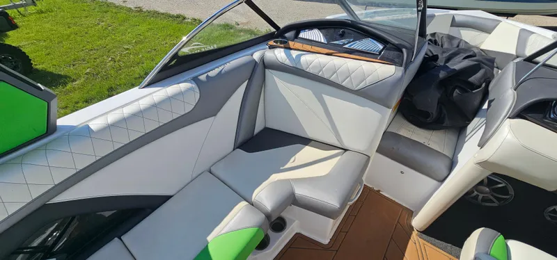 Slide: The Image of 2017 Tigé Z3 boat interior with white and gray seating, green accents, and wood flooring. - 13