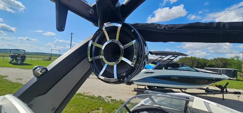 Slide: The Image of 2017 Tigé Z3 boat with tower speaker, parked outdoors under a clear blue sky. - 15