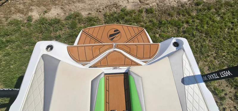 Slide: The Image of 2017 Tigé Z3 boat deck with teak finish and green accents on grass. - 18