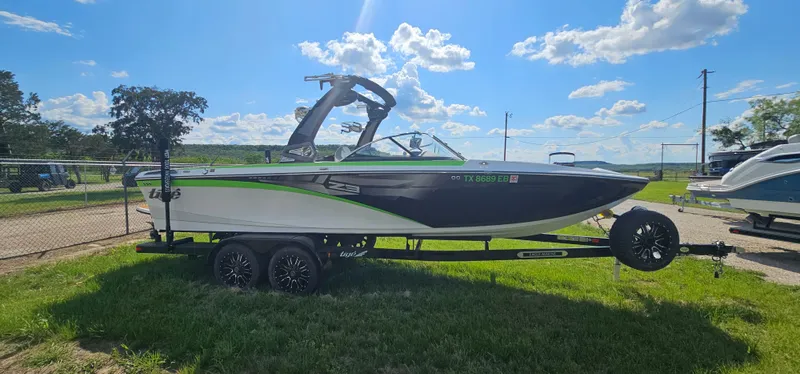 Slide: The Image of 2017 Tigé Z3 boat on trailer, parked on grass under a blue sky. - 4