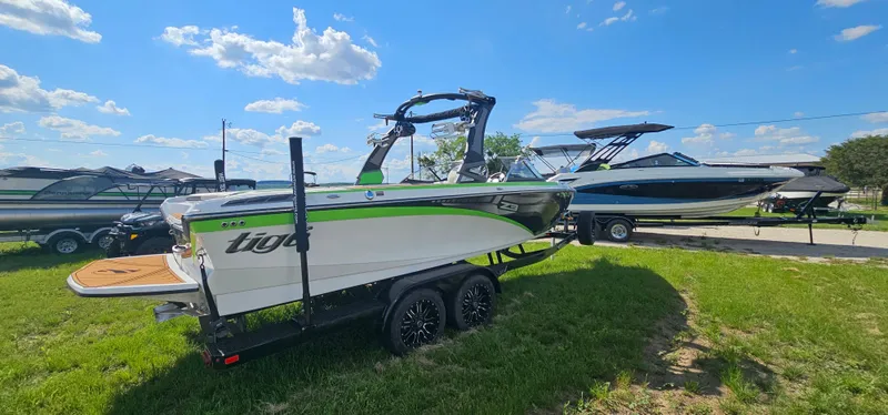 Slide: The Image of 2017 Tigé Z3 boat on trailer, parked on grass under a blue sky. - 5