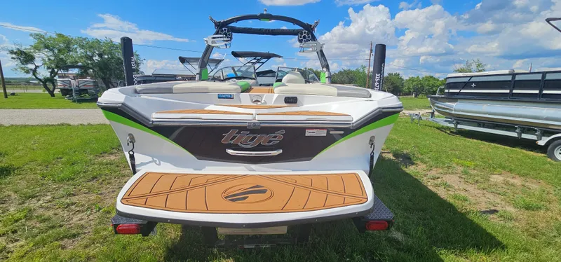 Slide: The Image of 2017 Tigé Z3 boat, rear view, parked on grass under a blue sky. - 6