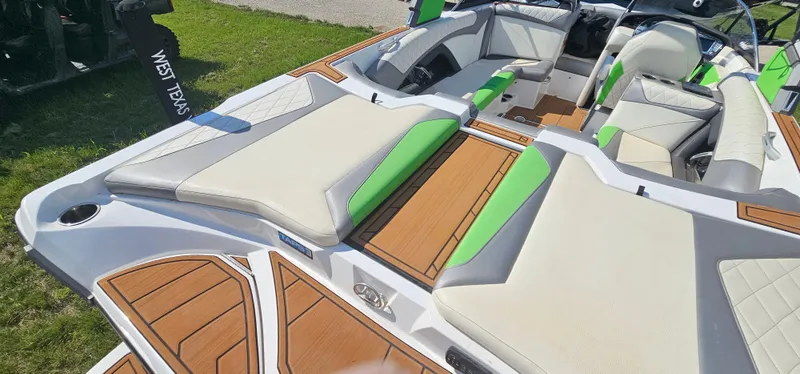 Slide: The Image of 2017 Tigé Z3 boat interior with green accents and cushioned seating. - 8