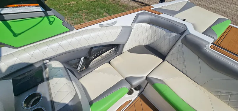 Slide: The Image of 2017 Tigé Z3 boat interior with green and white seating, featuring modern design and cup holders. - 9