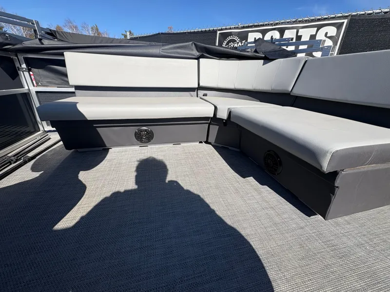 Slide: The Image of 2025 Custom Pontoon Maui with gray seating and carpeted deck under clear blue sky. - 10