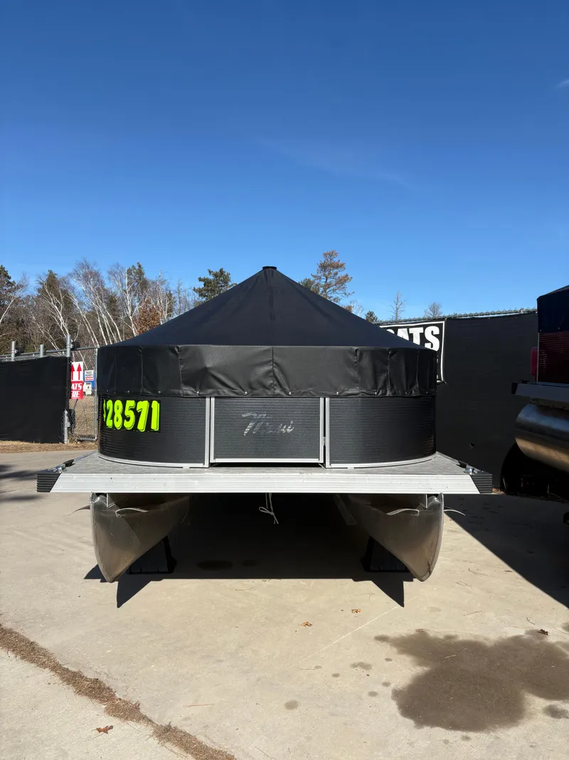 Slide: The Image of Custom 2025 Pontoon Maui with black canopy, parked outdoors on a sunny day. - 13