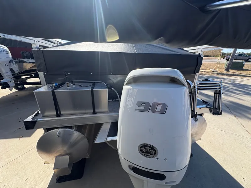 Slide: The Image of Custom 2025 Pontoon Maui with 90 HP engine, docked outdoors under sunlight. - 4