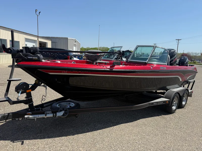 Slide: The Image of 2016 Yar-Craft 209TFX boat on trailer, red and black, parked outdoors. - 0