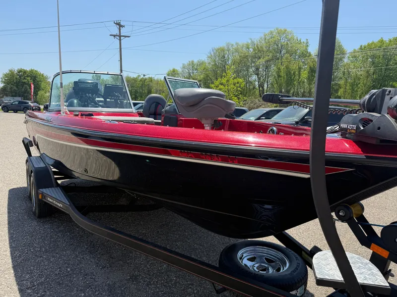 Slide: The Image of 2016 Yar-Craft 209TFX boat on trailer, red and black design, parked outdoors. - 10