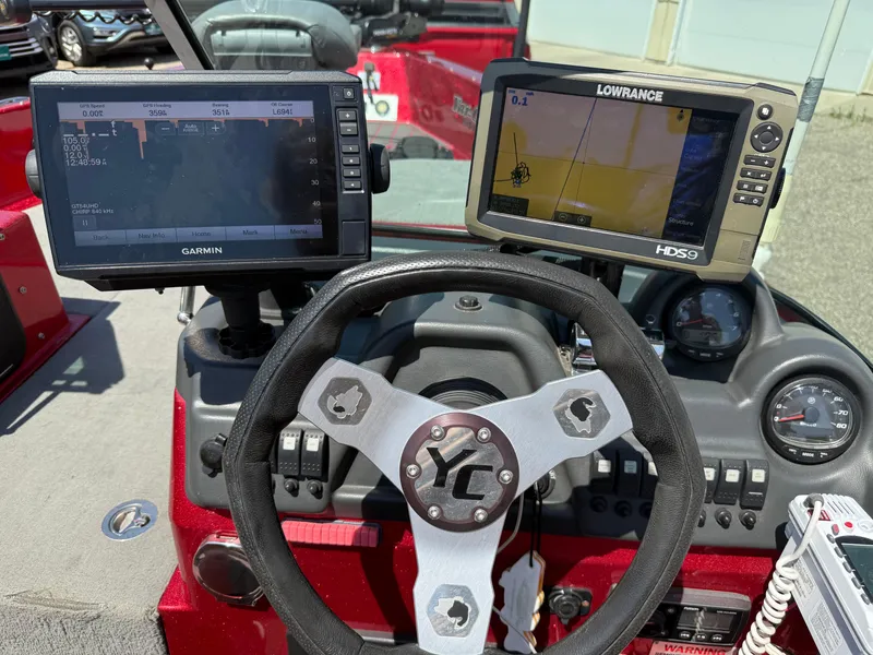 Slide: The Image of 2016 Yar-Craft 209TFX boat dashboard with Garmin and Lowrance navigation systems. - 16