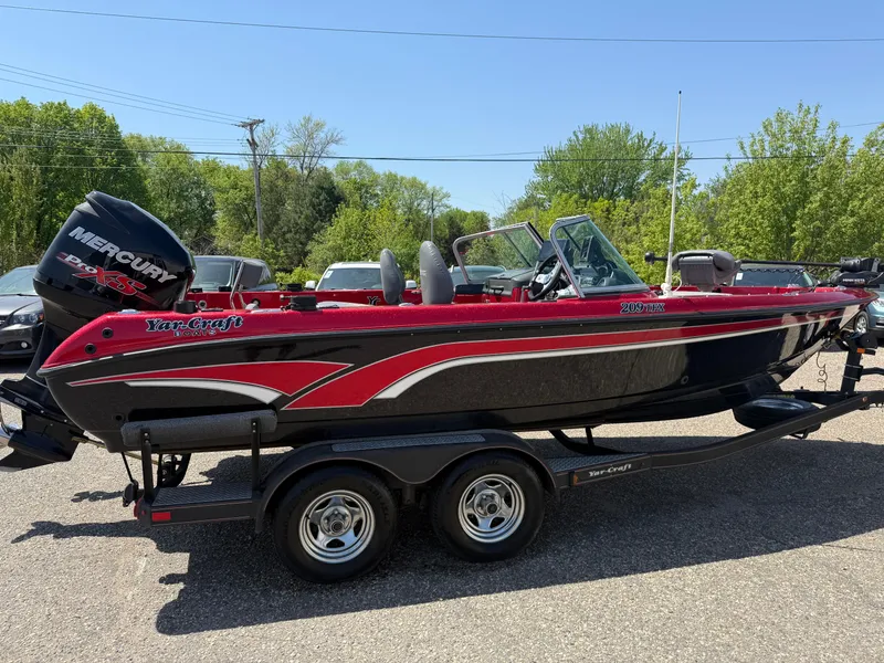 Slide: The Image of 2016 Yar-Craft 209TFX boat with Mercury engine on trailer, parked outdoors. - 2