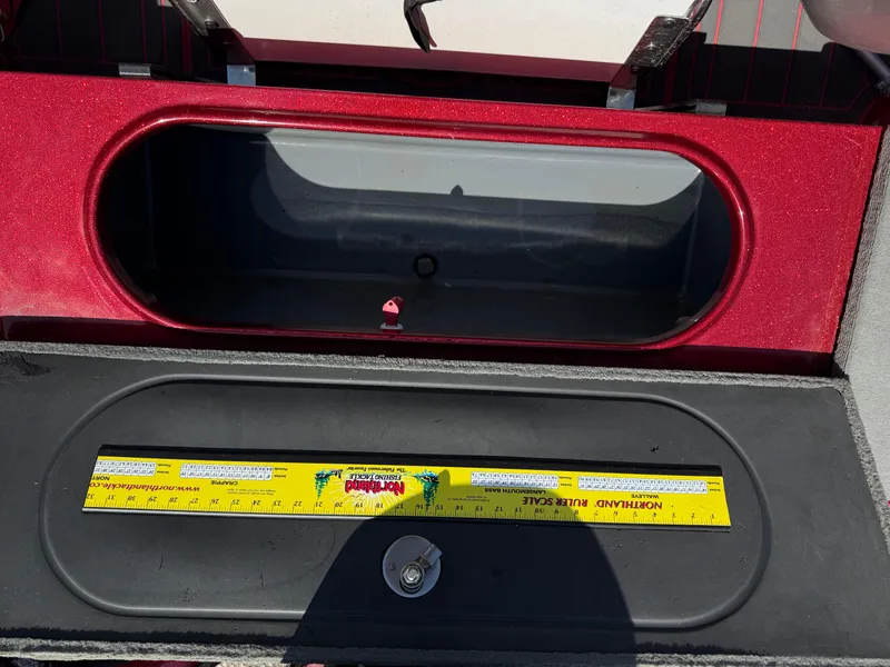 Slide: The Image of 2016 Yar-Craft 209TFX boat storage compartment with measuring ruler inside. - 23