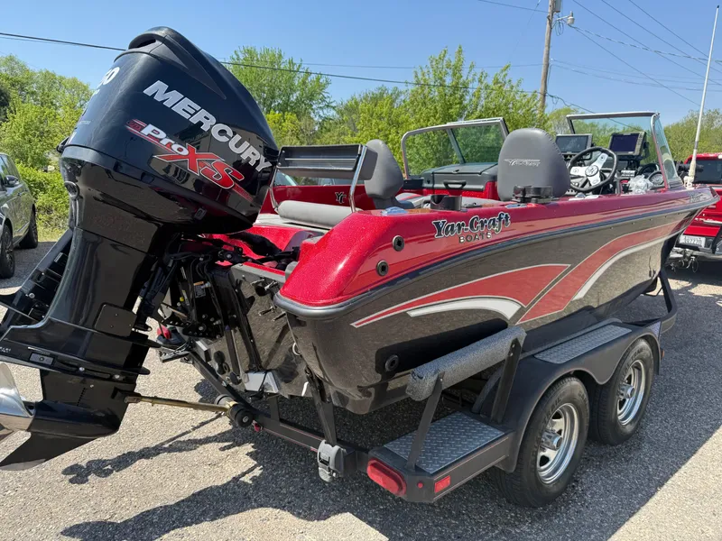 Slide: The Image of 2016 Yar-Craft 209TFX boat with Mercury Pro XS engine, red and black design, on trailer. - 3